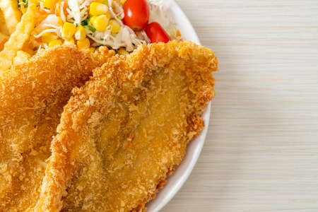 fish and chips with mini salad on white plateの写真素材