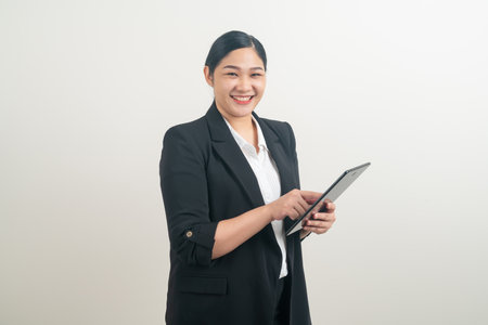 portrait Asian woman holding and using tablet with white backgroundの写真素材