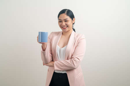 Asian woman with hand holding coffee cup on white backgroundの写真素材