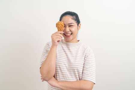portrait Asian woman with fried chicken on handの写真素材