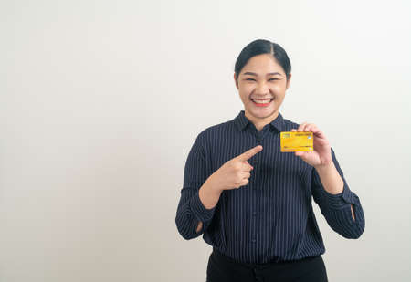 portrait Asian woman holding credit card with white backgroundの写真素材