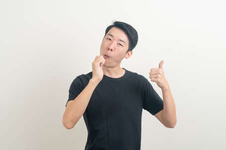 portrait young Asian man brush teeth on white backgroundの写真素材