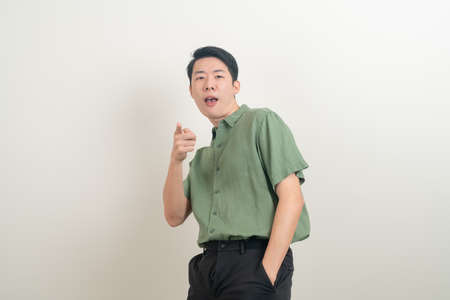 young Asian man with funny and crazy face on white backgroundの写真素材