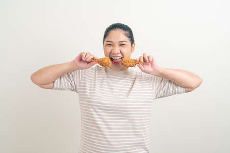 portrait Asian woman with fried chicken on handの写真素材