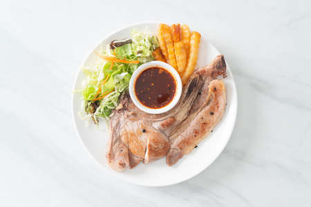 grilled pork chop steak with Thai spicy dipping sauce or Jaew sauce - fusion food styleの写真素材