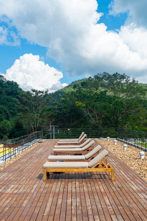 sun bed with mountain hill and blue sky background for sun bathの写真素材