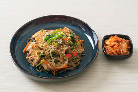 japchae or stir-fried Korean vermicelli noodles with vegetables and pork topped with white sesame - Korean traditional food styleの写真素材