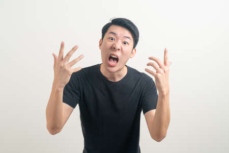 young Asian man with angry and mad face  on white backgroundの写真素材