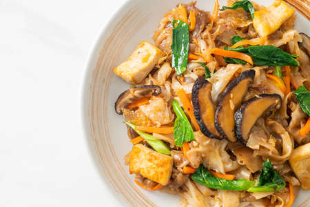 stir-fried noodles with tofu and vegetables - vegan and vegetarian food style