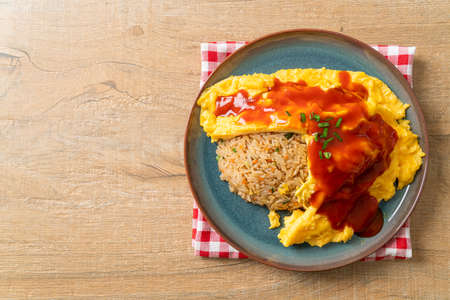 Flavored Fried Rice in an Omelet Wrapping or Omurice in Japanese style - Asian food styleの写真素材