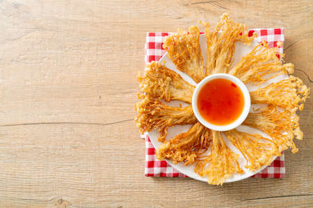deep fried enoki mushroom or golden needle mushroom with spicy dipping sauce - vegan food styleの写真素材