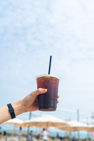 hand holding iced americano coffee with copy spaceの写真素材