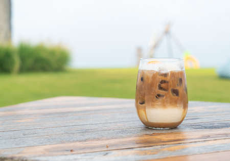 iced latte coffee glass on wood table