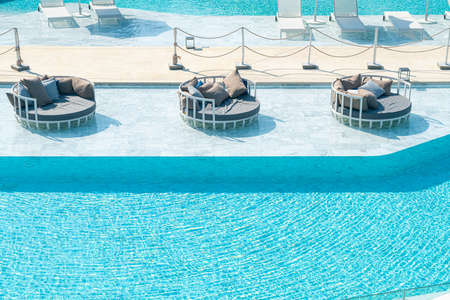 umbrella with bed pool around swimming pool - holiday and vacation conceptの写真素材
