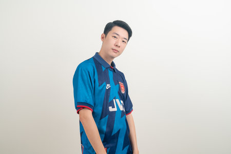 Bangkok, THAILAND - Nov 27, 2021 : Young Asian man wearing Arsenal shirt with white background....