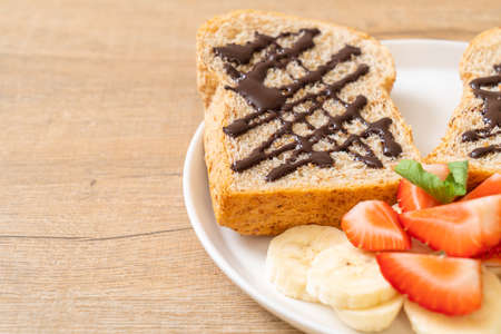 whole wheat bread toasted with fresh banana, strawberry and chocolate for breakfastの写真素材