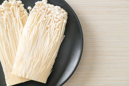 fresh enoki mushroom or golden needle mushrooms on plate