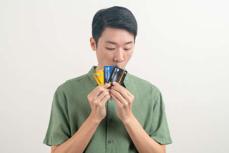 portrait young Asian man holding credit card on white background