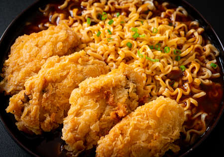 Korean instant noodles with fried chicken or Fried chicken ramyeon - Korean food styleの写真素材