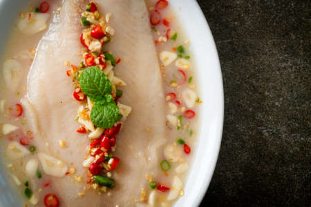 Steamed Fish in Spicy Lemon Sauce on white plate