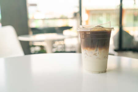 iced latte coffee cup on table in cafe coffee shopの写真素材