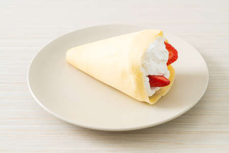 fresh strawberry and fresh cream crepe on plateの写真素材