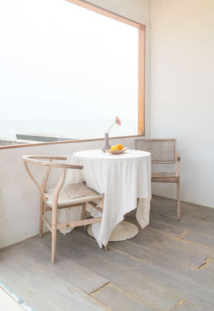 empty minimal table and chair on side window