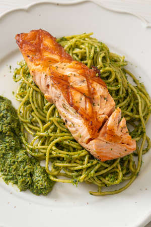 Spaghetti pesto with grilled salmon - Italian food styleの写真素材