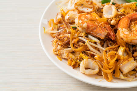 Pad Thai Seafood - Stir fried noodles with shrimps, squid or octopus and tofu in Thai styleの写真素材