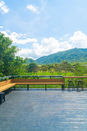 empty bench and bar stool on balcony with mountain hill backgrpundの写真素材