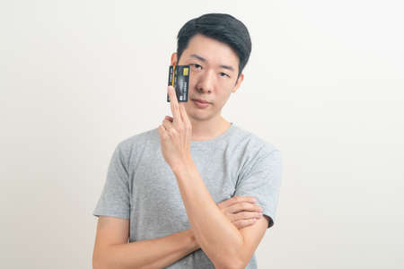 portrait young Asian man holding credit card on white background