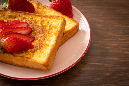 french toast with fresh strawberry on plateの写真素材