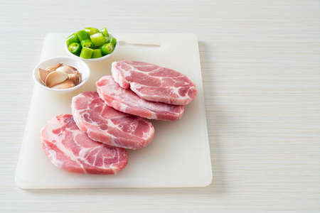 fresh pork neck raw or collar pork on board with ingredients for marinatedの写真素材