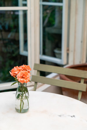 beautiful rose flower in vase decorated on table in cafe restaurantの写真素材