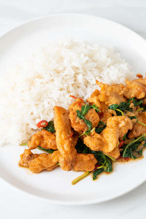 stir-fried fried fish with basil and chili in thai style topped on rice - Asian food styleの写真素材