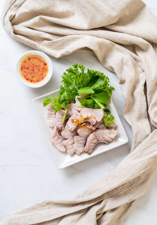 Boiled fish dip with sauce and vegetableの写真素材