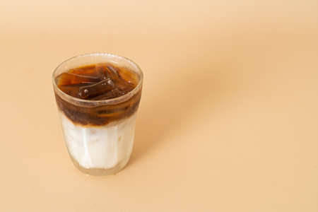 iced black coffee with milk layer in glass