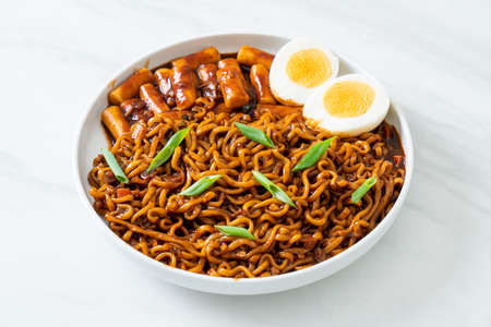 Jjajang Rabokki - Korean instant noodles or Ramyeon with Korean rice cake or Tteokbokki and egg in black bean sauce - Korean food styleの写真素材