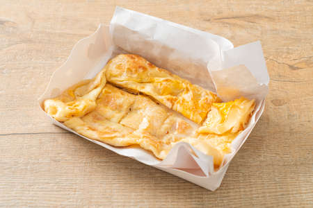 fried roti with egg and sweetened condensed milk