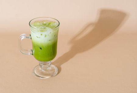 iced matcha green tea latte with milk layer in glassの写真素材
