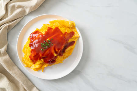 Flavored Fried Rice in an Omelet Wrapping or Omurice in Japanese style - Asian food styleの写真素材