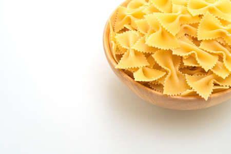 Dry uncooked farfalle pasta isolated on white background