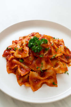 farfalle pasta in tomato sauce with parsley - Italian food style