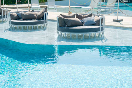 umbrella with bed pool around swimming pool - holiday and vacation concept