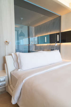 white comfortable pillows decoration on bed in a roomの写真素材