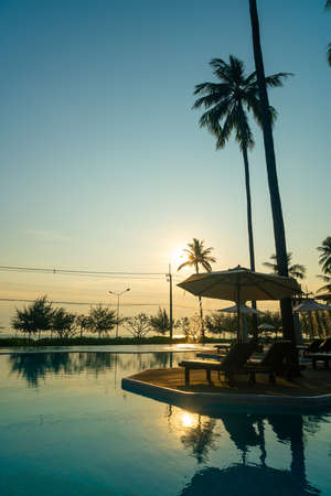umbrella with bed pool around swimming pool with ocean sea background - holiday and vacation conceptの写真素材