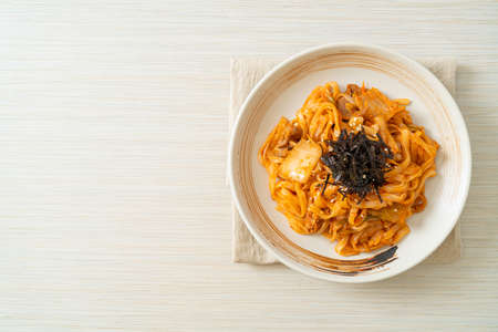stir-fried udon noodles with kimchi and pork - Korean food styleの写真素材