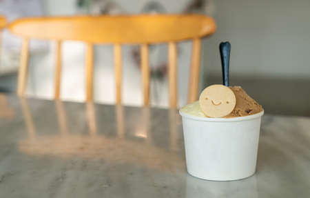 vanilla and caramel ice-cream with biscuit in cupの写真素材