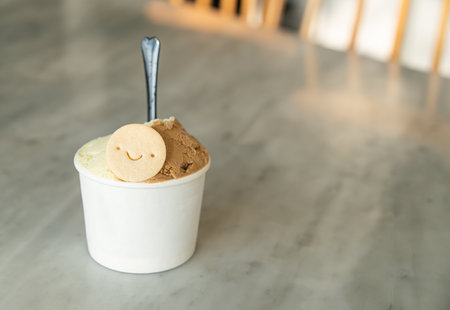 vanilla and caramel ice-cream with biscuit in cupの写真素材