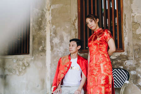 Happy young Asian couple love in Chinese traditional dresses - Red is the main color of the traditional festive that including wedding in China.の写真素材